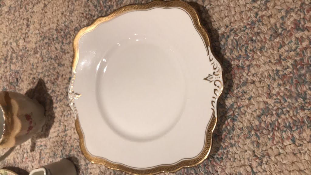 Original photo showing gold-rimmed plate before cleanup
